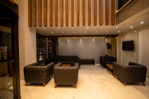 a large living room with couches and a tv at SARDUR HOTEL in Bostaniçi