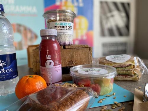 a table topped with food and a jar of jam at Ramada by Wyndham Amsterdam Airport Schiphol in Badhoevedorp