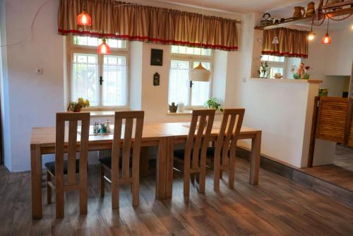 a dining room with a wooden table and chairs at U Broučků in Lipova Lazne