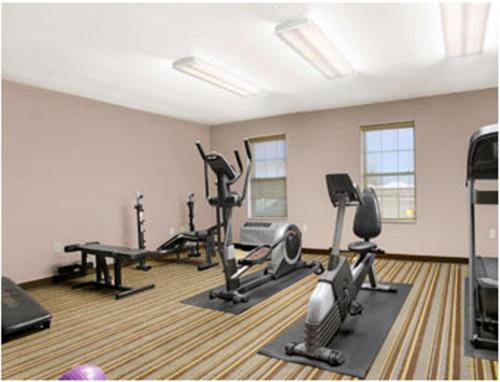 a gym with several treadmills and exercise bikes at Super 8 by Wyndham Stafford/Springfield Area in Strafford