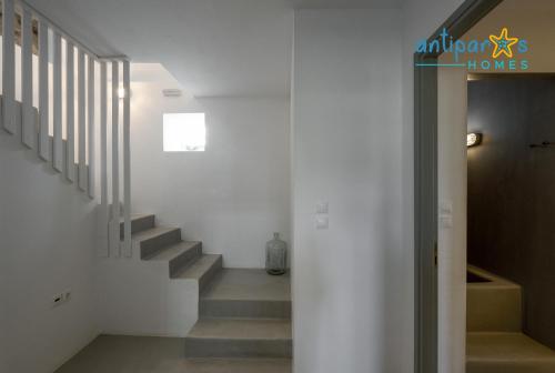 a hallway with stairs in a house at Antiparos Homes in Antiparos Town
