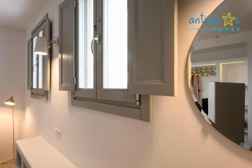a bathroom with a mirror and a sink at Antiparos Homes in Antiparos Town