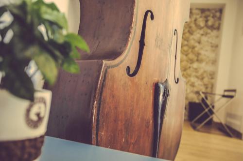 a wooden vase sitting on a table with a plant at Langhe Country House in Neive