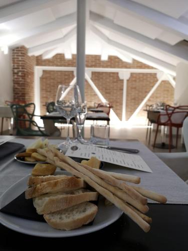 a plate of bread and french fries on a table at Best Western Plus Royal Superga Hotel in Cuneo