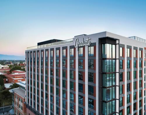 a building with a sign on the top of it at Graduate by Hilton Tucson in Tucson