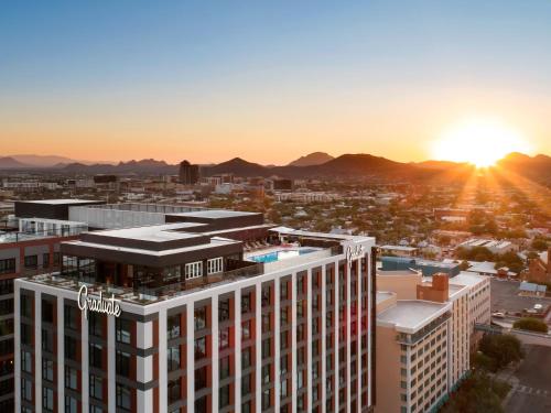 an aerial view of a building with the sunset in the background at Graduate by Hilton Tucson in Tucson