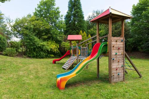 a playground with a colorful slide and a gazebo at Vitalhotel Marienhof in Velden am Wörthersee