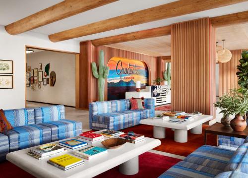 a living room with blue couches and tables at Graduate Tucson in Tucson