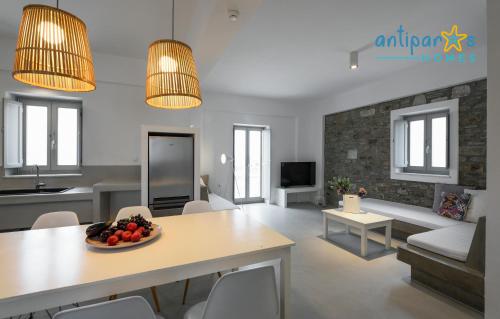 a living room with a table with a bowl of fruit on it at Antiparos Homes in Antiparos Town