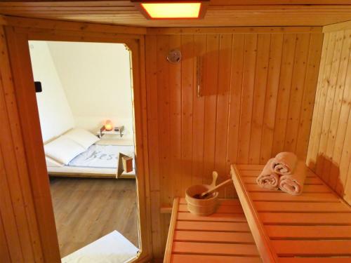 a small sauna with a bed in the background at Land & Meer in Hasselberg