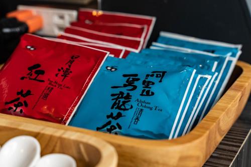 a wooden tray filled with chopsticks and books at Sleeping Inn in Hualien City