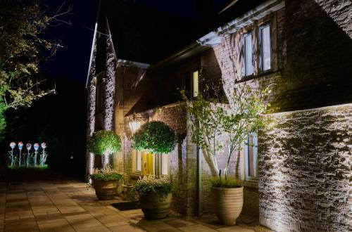 a building with potted plants on the side of it at night at Homewood Hotel & Spa - Small Luxury Hotels of the World in Bath