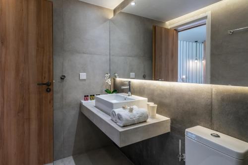 a bathroom with a sink and a toilet at Malama Beach Holiday Village in Protaras