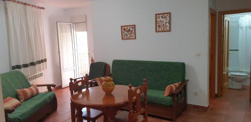 a living room with a couch and a table at Apartamentos Valle del Guadalquivir in Arroyo Frio