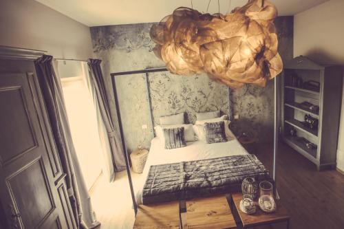 a small bedroom with a bed and a mirror at Langhe Country House in Neive