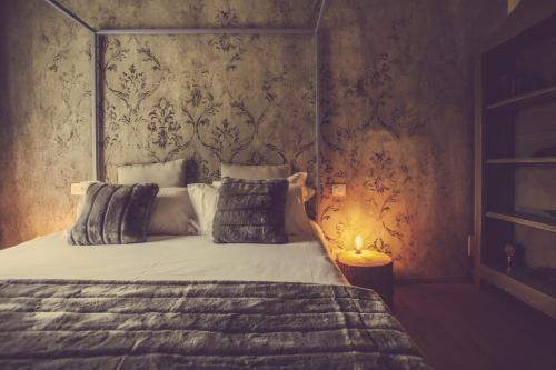 a bedroom with a large bed with a canopy at Langhe Country House in Neive