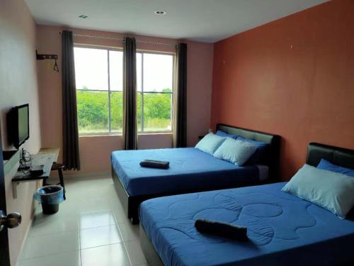 Ліжко або ліжка в номері CSH Motel Kuala Perlis