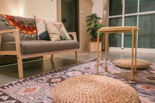 a living room with a couch and a table and a rug at 艾迪行旅民宿 in Ruisui
