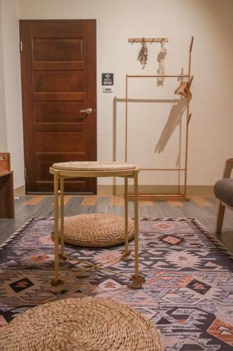 a room with a table and a door and a rug at 艾迪行旅民宿 in Ruisui