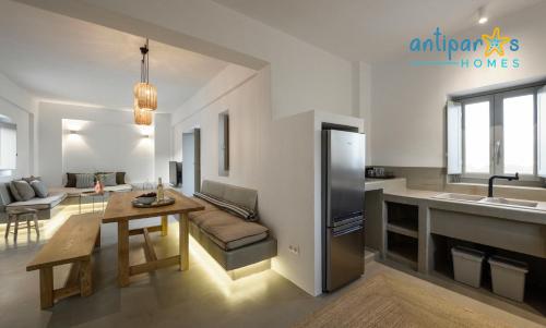 a kitchen and living room with a couch and a table at Antiparos Homes in Antiparos Town