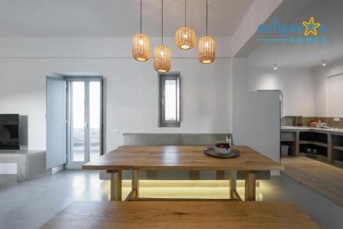 a dining room with a wooden table in a room at Antiparos Homes in Antiparos Town