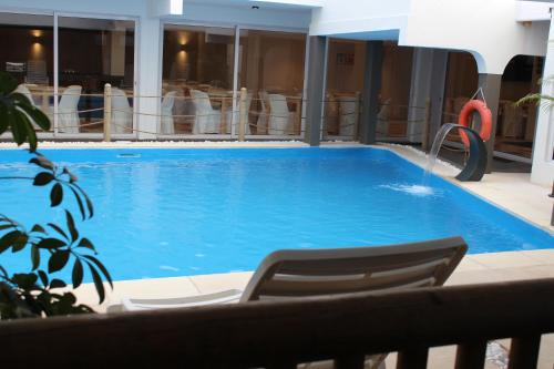 a large swimming pool with chairs in a hotel at Sikamifer Tourist Resort in Quatre Bornes