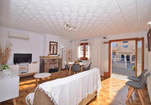 a bedroom with a bed and a living room at 146 Casa Starfish ETV6542 by Mallorca Charme in Can Picafort