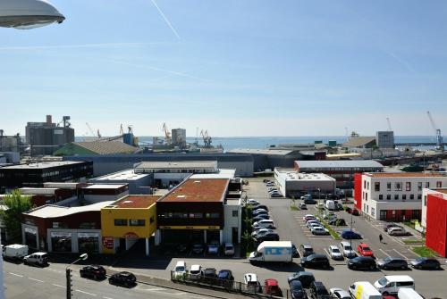 a city with cars parked in a parking lot at Appart Cosy Brest (La gare) vue mer in Brest