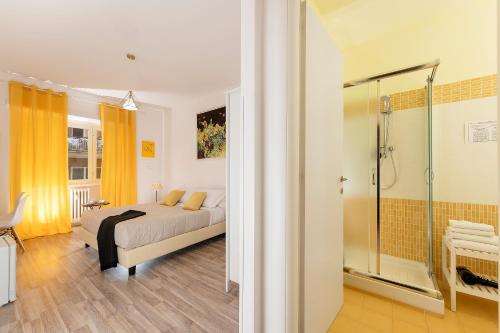 a bedroom with a bed and a shower at Aurelia Home Guest House in Rome