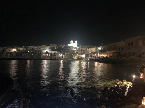 a view of a city at night with the water at Sea & Sun Paros in Naousa