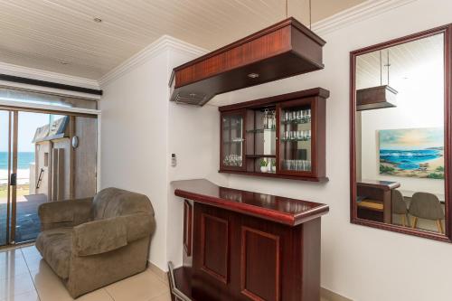 a living room with a bar and a chair at Boulder Bay 4 in Ballito