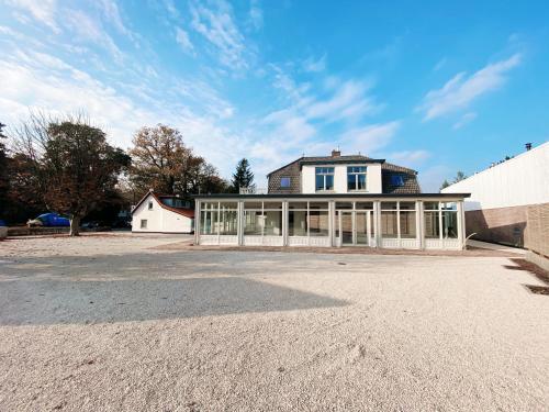 a large house with a lot of windows at Luxurious historical Loft close to the beach! in Wassenaar