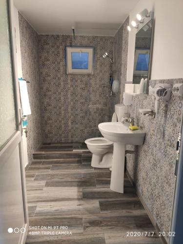 a bathroom with a toilet and a sink at Blue Bungalow Jurilovca in Jurilovca