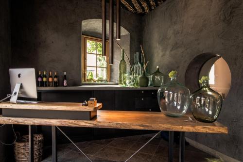 a table with two glass vases on top of it at Hotel / Weingut Meintzinger in Frickenhausen