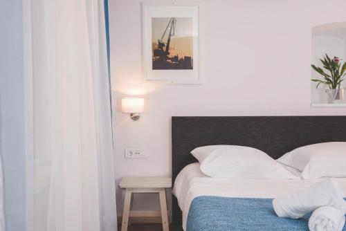 a bedroom with a bed and a table and a picture at Old Town Inn in Rijeka