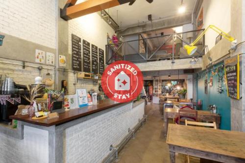 a restaurant with a counter with a sign on it at Box Hostel N Cafe in Chiang Mai