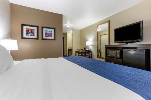 a hotel room with a bed and a flat screen tv at Comfort Inn & Suites Surprise Near Sun City West in Surprise