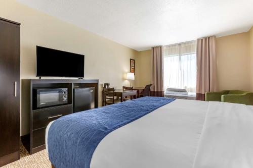 a hotel room with a bed and a flat screen tv at Comfort Inn & Suites Surprise Near Sun City West in Surprise