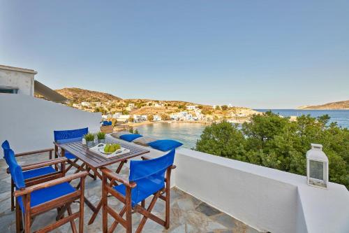 a table and chairs on a balcony with a view of the ocean at Psathi Blue Alpha in Kimolos