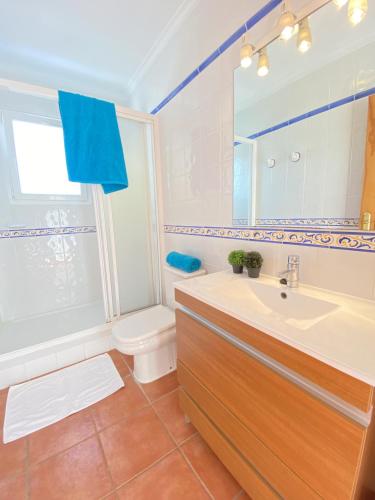 a bathroom with a sink and a toilet and a mirror at Villas Molins - BTB in Denia