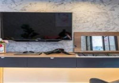 a counter in a room with a mirror and a table at KLIA Glorybnb Bell Suites in Sepang