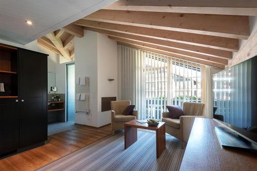 a living room with a table and chairs at Mirabeau Alpine in Zermatt