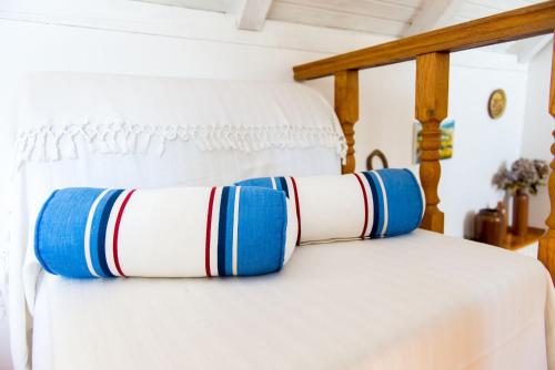 a bed with blue and white pillows on it at Rooms Lavanda&Ruzmarin in Dubrovnik