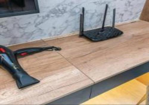 a pair of scissors on top of a wooden counter at KLIA Glorybnb Bell Suites in Sepang