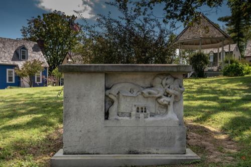 a stone monument in a park with an animal on it at Century Suites Hotel in Bloomington