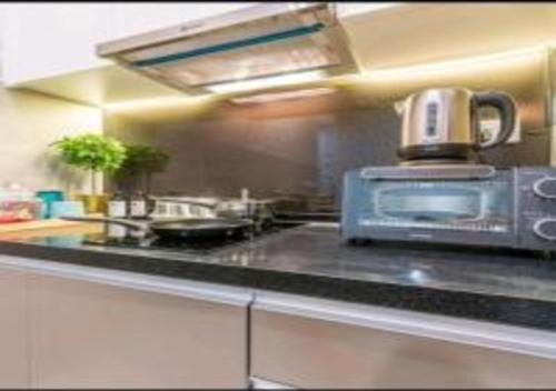 a kitchen with a coffee pot on top of a counter at KLIA Glorybnb Bell Suites in Sepang