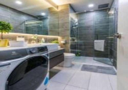 y baño con ducha y lavadora. en KLIA Glorybnb Bell Suites en Sepang