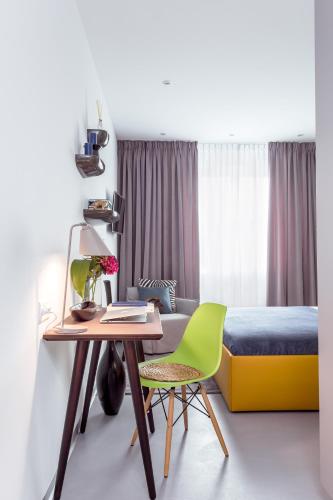 a bedroom with a bed and a desk and a table at VISIONAPARTMENTS Vevey - contactless check-in in Vevey