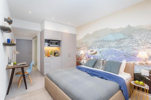 a bedroom with a king sized bed and a kitchen at VISIONAPARTMENTS Rue des Communaux - contactless check-in in Vevey