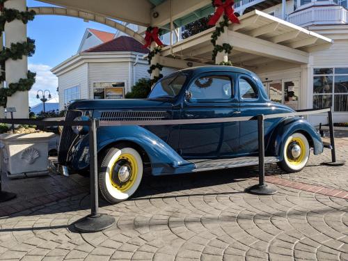 an old blue car is on display on a street at Rod 'N' Reel Resort in Chesapeake Beach